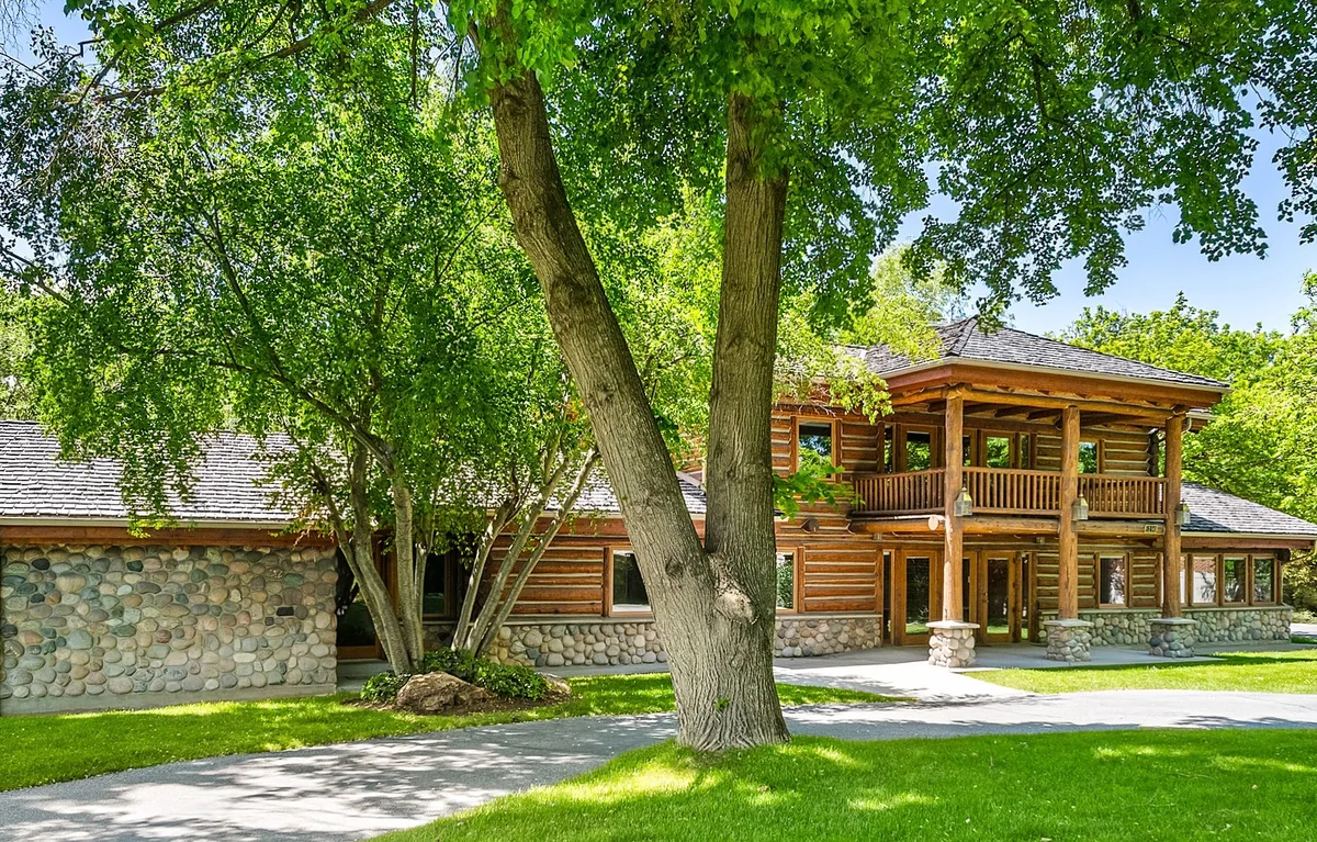 Historic Fabian Cabin shaded by mature trees beside the creek