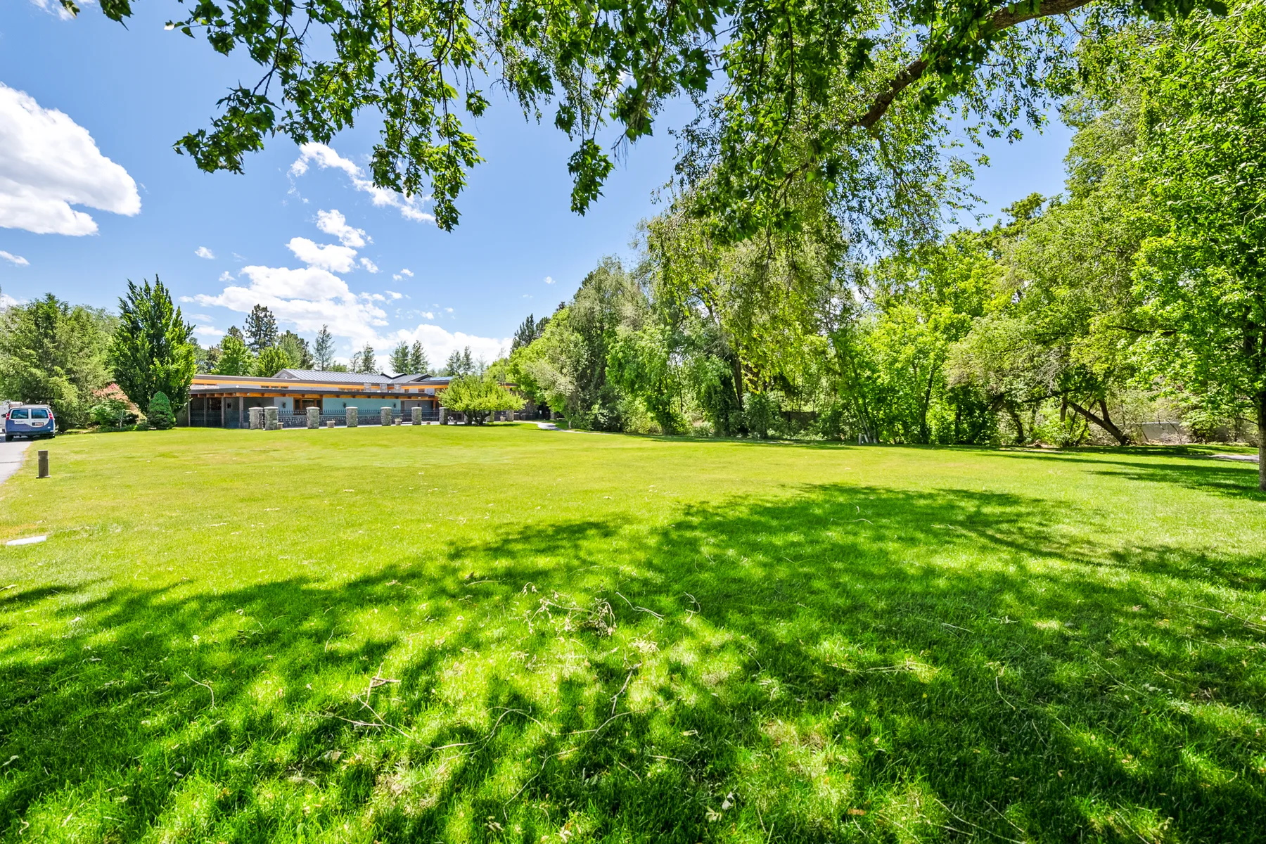 Approximately one-acre home site with open lawn and mature tree canopy