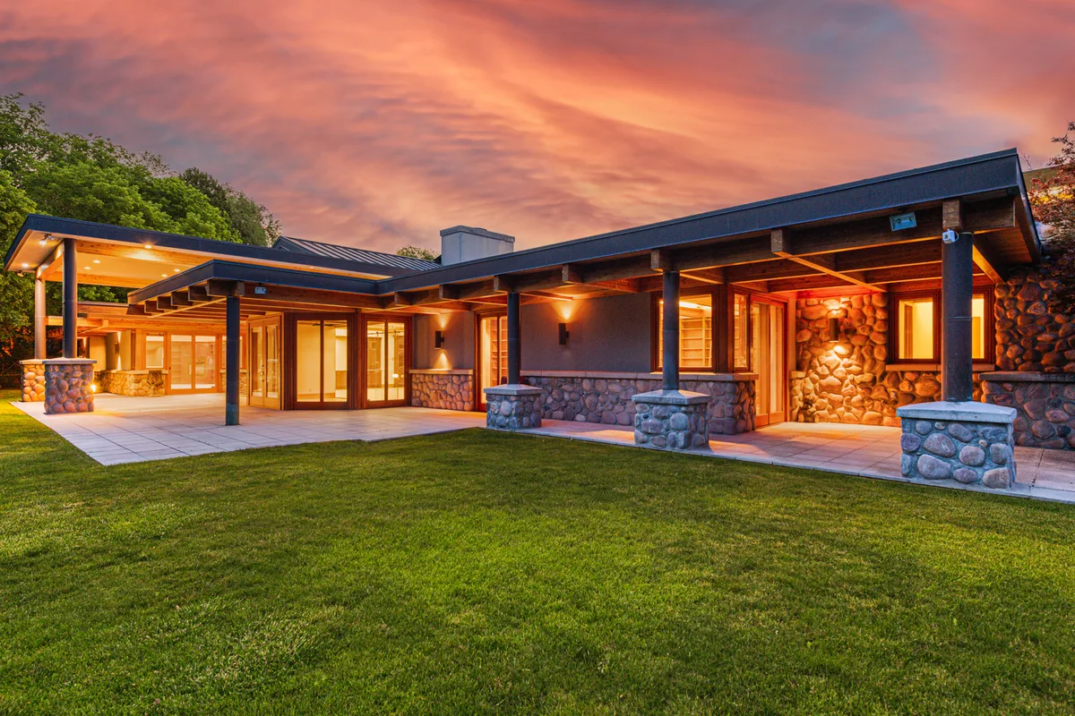 The main residence glowing at twilight