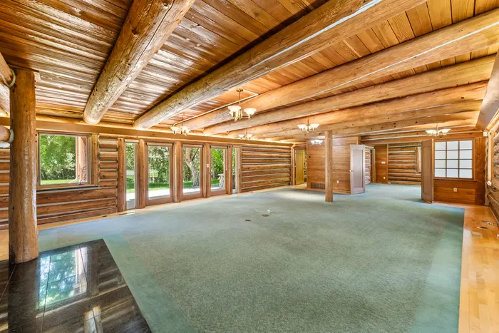 Open log great room with garden windows