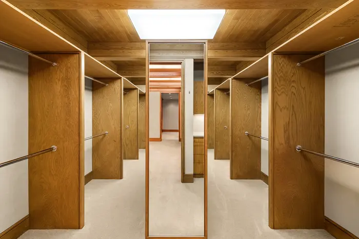 Walk-in wardrobe with custom wood storage