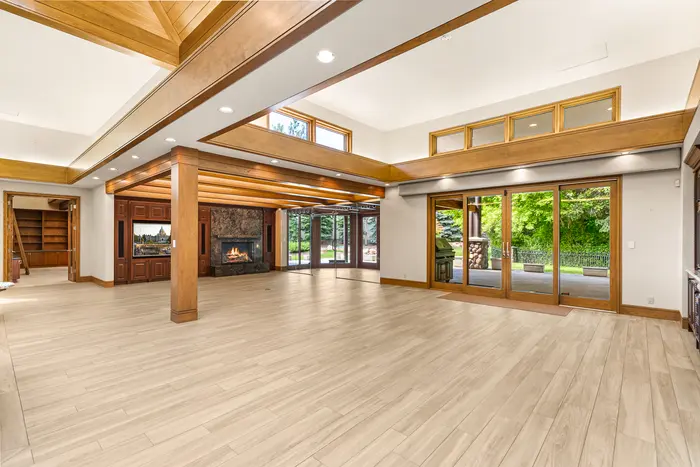 Open great room with timber ceiling and garden windows