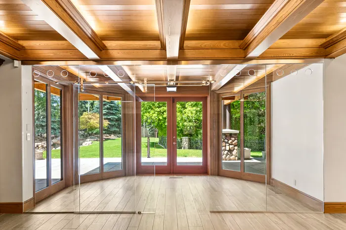 Garden room with glass doors and timber ceiling