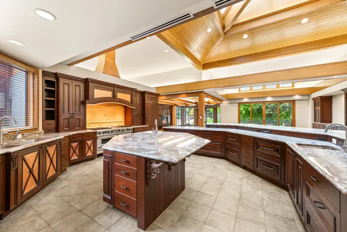 Expansive kitchen workspace beneath a skylit ceiling