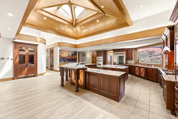 Kitchen with wood cabinetry and skylit ceiling